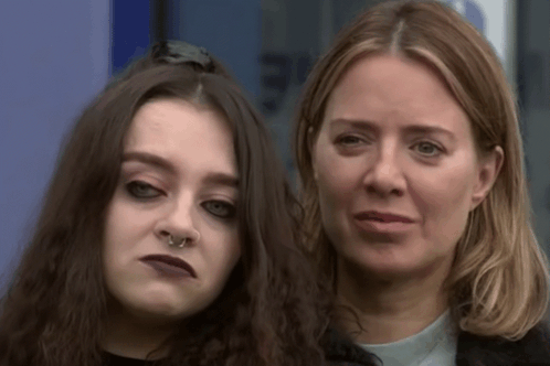 A Woman With A Nose Ring Is Standing Next To A Younger Woman GIF