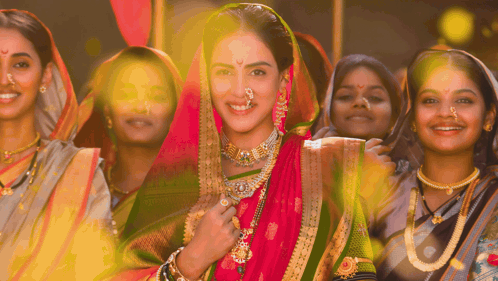 A Woman With A Nose Ring Is Surrounded By A Group Of Women GIF