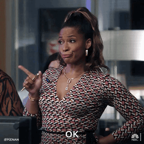 A Woman With A Pen In Her Hand And The Word Ok On The Bottom GIF