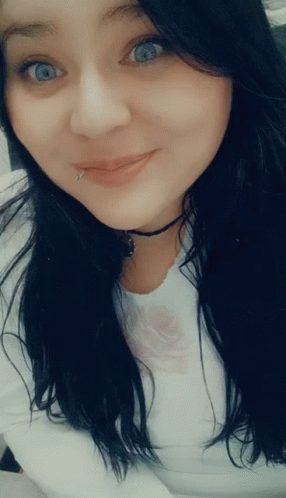 A Woman With A Piercing In Her Lip Is Smiling GIF