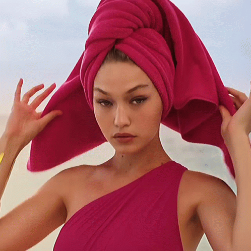A Woman With A Pink Towel Around Her Head GIF