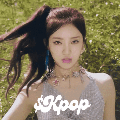 A Woman With A Ponytail And A Necklace With The Word Kpop On It GIF