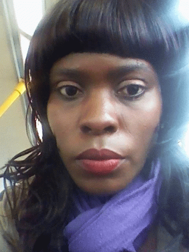 A Woman With A Purple Scarf Around Her Neck GIF