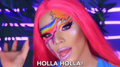 A Woman With A Rainbow Painted On Her Face Says Holla Holla GIF