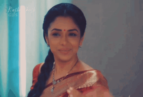 A Woman With A Red Dot On Her Forehead Is Smiling In Front Of A Sign That Says Kashi Dash Gifs GIF
