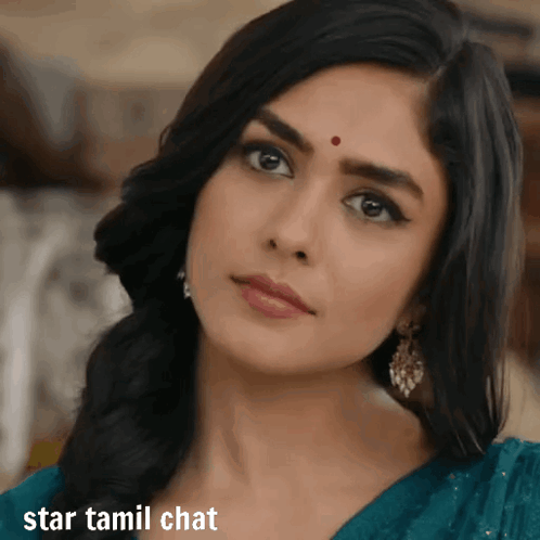 A Woman With A Red Dot On Her Forehead Looks At The Camera With The Words Star Tamil Chat Below Her GIF