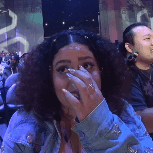 A Woman With A Ring On Her Finger Covering Her Face GIF