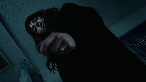 A Woman With A Ring On Her Finger Is Laying On The Floor GIF