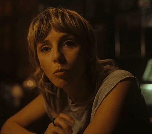 A Woman With A Ring On Her Finger Is Looking At The Camera GIF