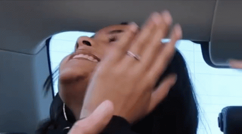 a woman with a ring on her finger is smiling and clapping