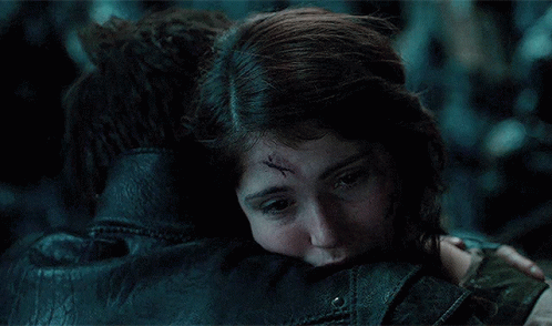 A Woman With A Scar On Her Forehead Is Hugging A Man In A Leather Jacket GIF
