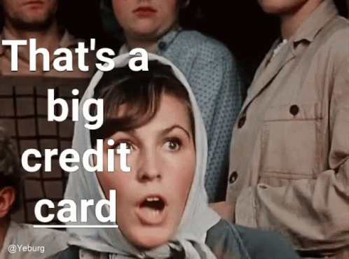 A Woman With A Scarf Around Her Head And The Words That 'S A Big Credit Card Above Her GIF