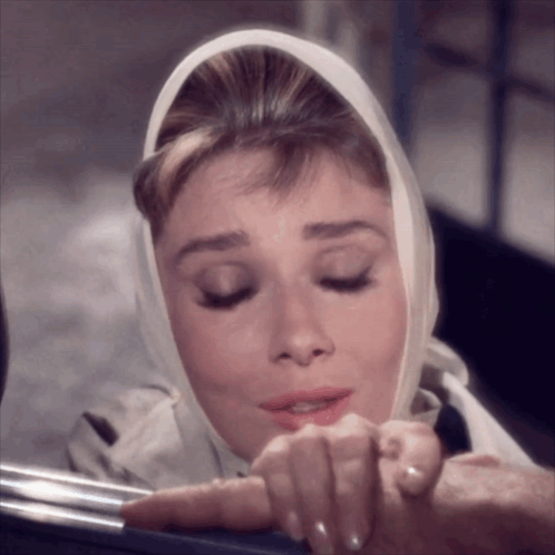 Woman With Scarf Looking Down GIF