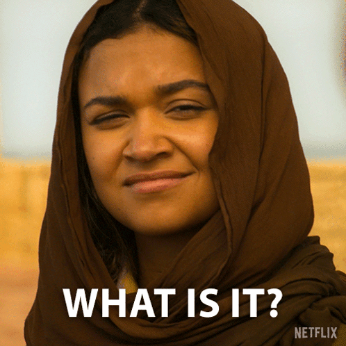 A Woman With A Scarf Around Her Head Says What Is It On The Bottom GIF