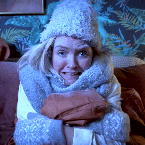 A Woman With A Scarf Around Her Neck And A Hat On GIF