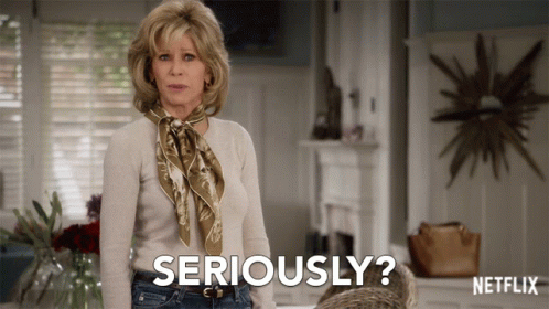 A Woman With A Scarf Around Her Neck Is Saying Seriously GIF