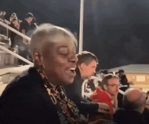 A Woman With A Scarf Around Her Neck That Says ' U.s.a. ' GIF