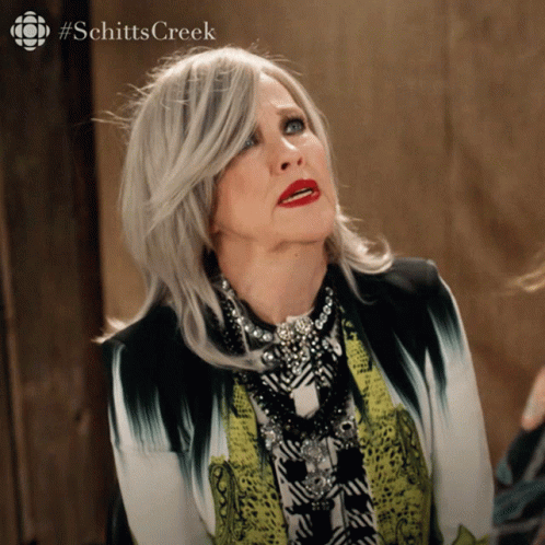 A Woman With A #Schitts Creek Logo On The Bottom Right GIF