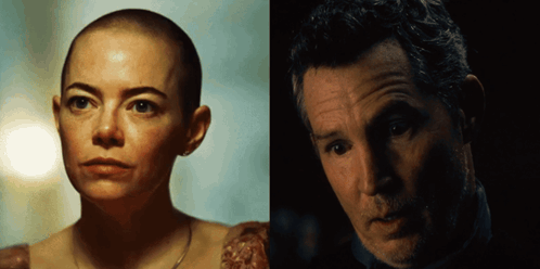a woman with a shaved head is next to a man with gray hair