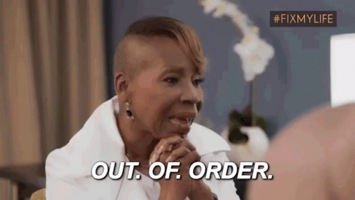 A Woman With A Shaved Head Is Sitting In A Chair And Says `` Out Of Order '' . GIF