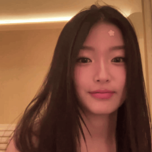 A Woman With A Star On Her Forehead Looks At The Camera GIF