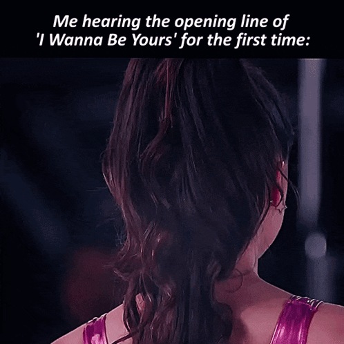 A Woman With A Star Shaped Earring On Her Left Ear Looks At The Camera GIF