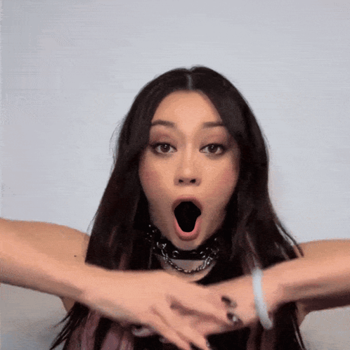 A Woman With A Surprised Look On Her Face And Her Mouth Open GIF
