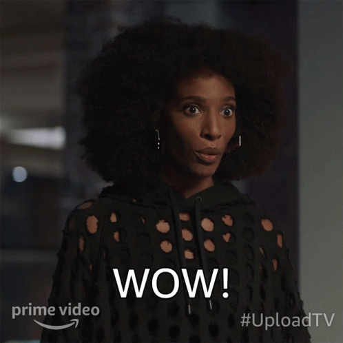 A Woman With A Surprised Look On Her Face And The Word Wow On The Bottom Right GIF