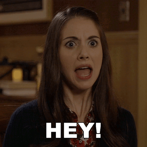 A Woman With A Surprised Look On Her Face And The Words Hey Written On Her Face GIF