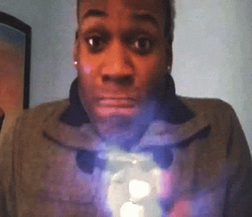 A Woman With A Surprised Look On Her Face Is Holding A Light GIF