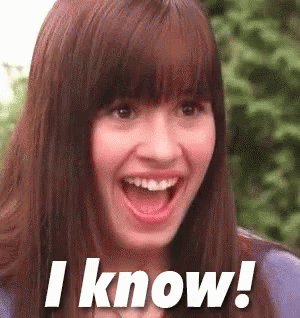 A Woman With A Surprised Look On Her Face Is Smiling And Says I Know . GIF