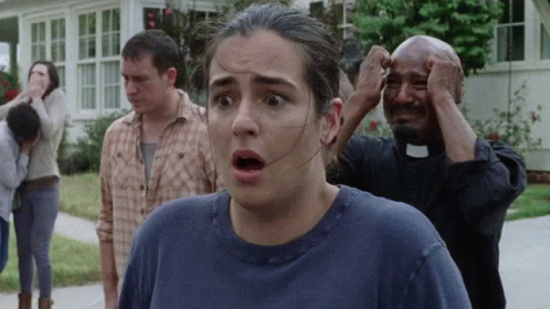 A Woman With A Surprised Look On Her Face Is Standing Next To A Priest GIF