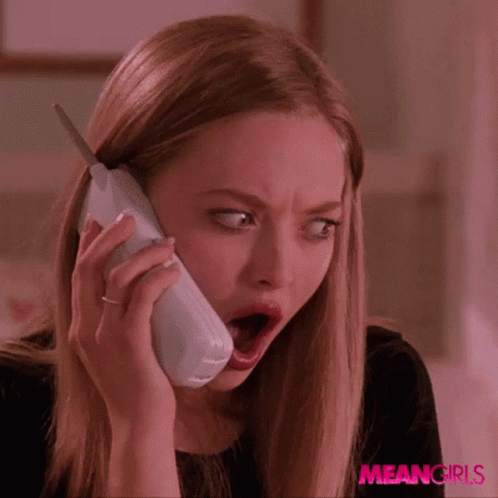 A Woman With A Surprised Look On Her Face Is Talking On A Phone With Meangirls Written On The Bottom Right GIF