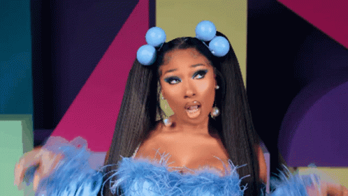 a woman with a surprised look on her face is wearing a blue feathered top