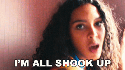 A Woman With A Surprised Look On Her Face Says I 'M All Shook Up . GIF