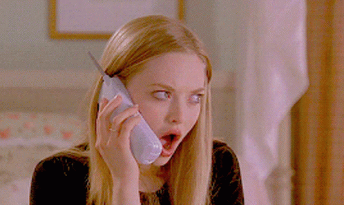 A Woman With A Surprised Look On Her Face Talking On A Cell Phone GIF