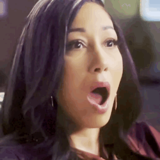 A Woman With A Surprised Look On Her Face . GIF