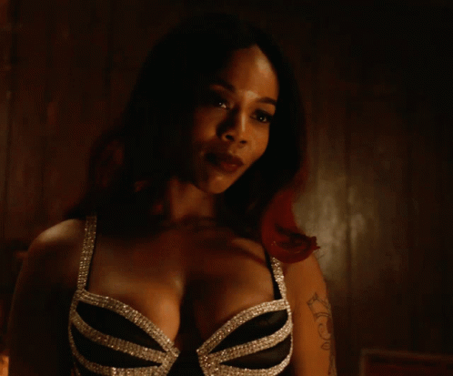 A Woman With A Tattoo On Her Arm Has A Bra On GIF