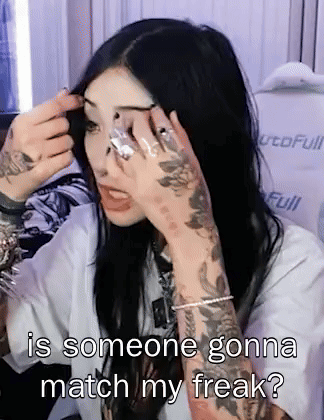 A Woman With A Tattoo On Her Arm Is Applying Makeup With The Caption Is Someone Gonna Match My Freak GIF