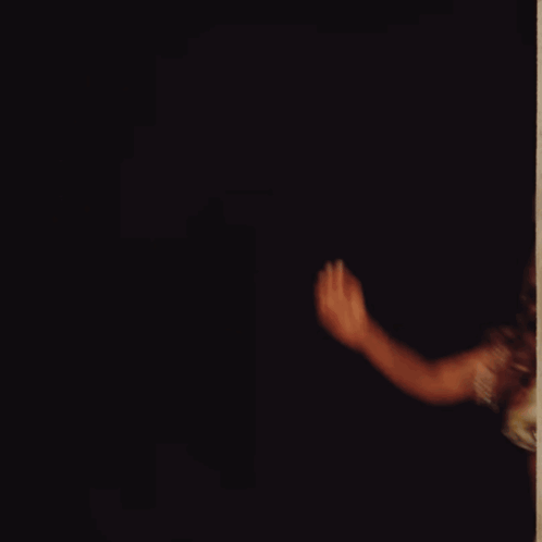 A Woman With A Tattoo On Her Arm Is Dancing GIF