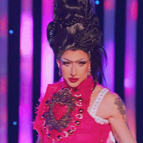 A Woman With A Tattoo On Her Arm Is Wearing A Red Dress GIF