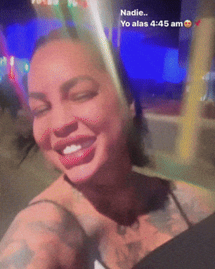 A Woman With A Tattoo On Her Chest Is Smiling And Says Nadie GIF