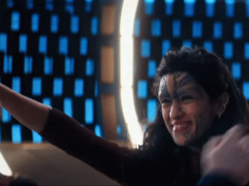 A Woman With A Tattoo On Her Face Is Smiling While Taking A Selfie GIF
