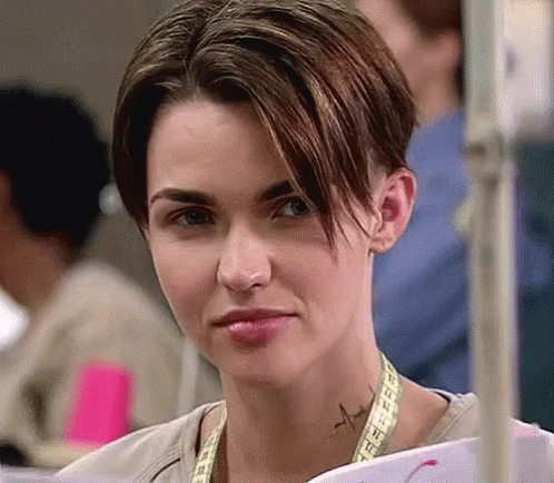 A Woman With A Tattoo On Her Neck Is Holding A Piece Of Paper . GIF
