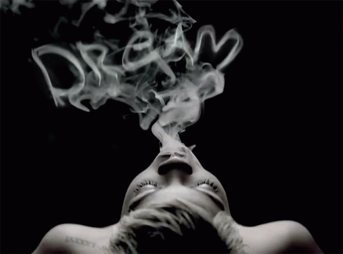A Woman With A Tattoo On Her Neck Is Smoking GIF
