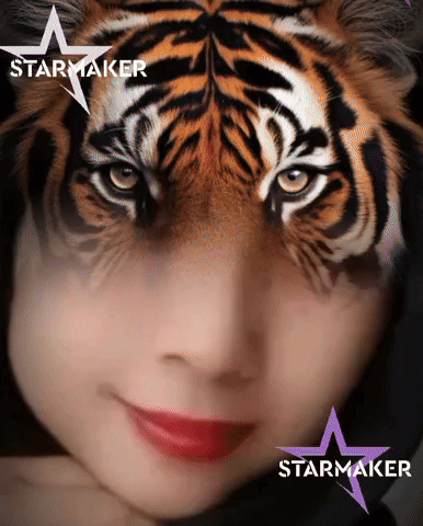 a woman with a tiger face painted on her face and the word starmaker on the bottom