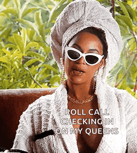 A Woman With A Towel Wrapped Around Her Head And Sunglasses Is Sitting On A Couch . GIF
