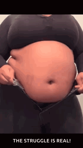 Woman With Large Belly In Black Shirt And Jeans GIF