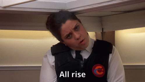 A Woman With A Vest That Says All Rise On It GIF