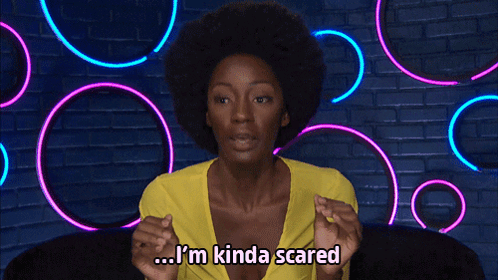 A Woman With An Afro Says I 'M Kinda Scared In Front Of Neon Lights GIF